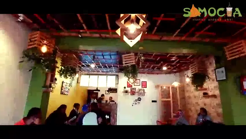 People spending time inside a warmly lit Samocha outlet